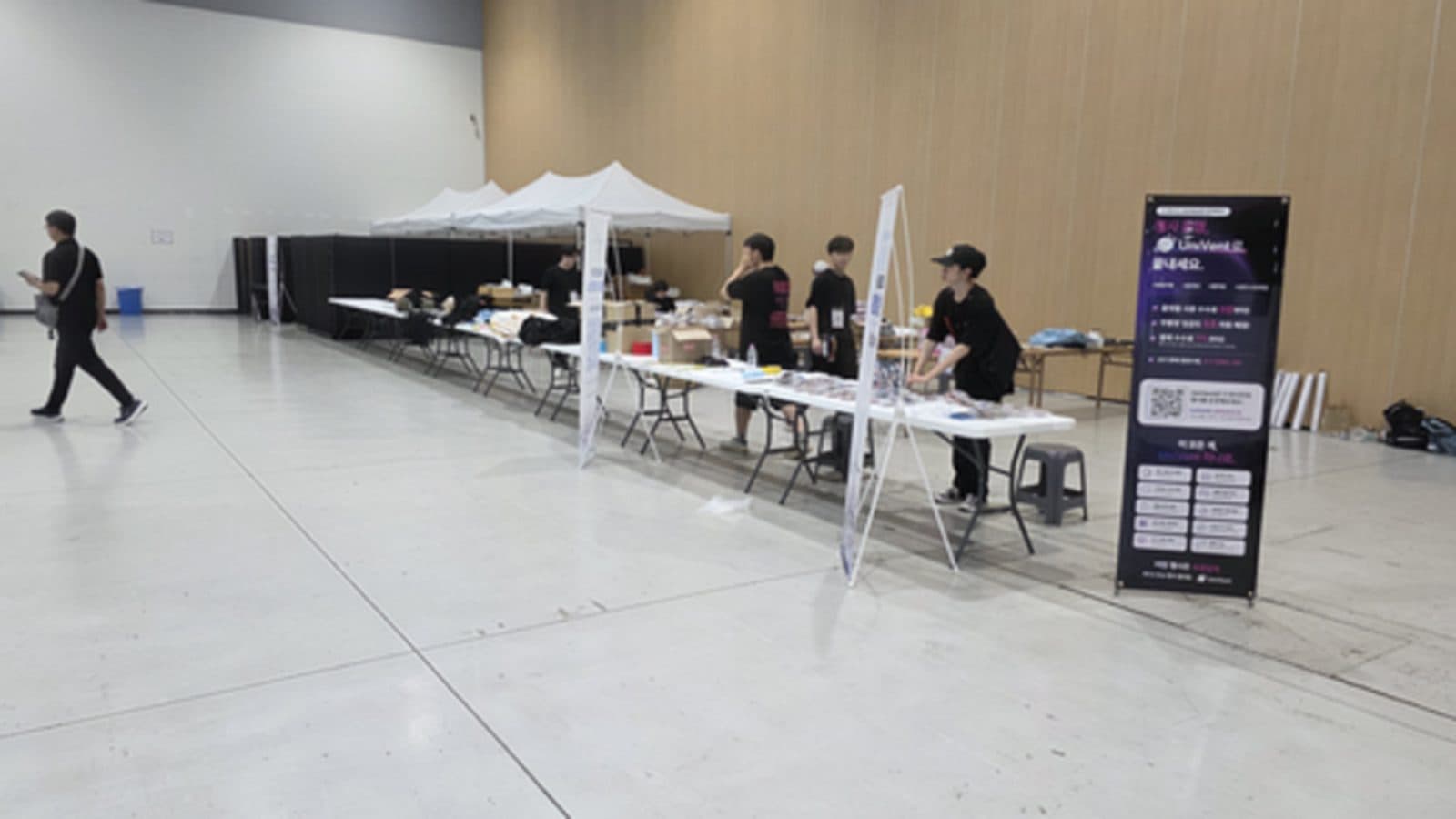 문을 열기 전 아침, 천막과 테이블을 펴고 있는 홀로즈마 운영 본부